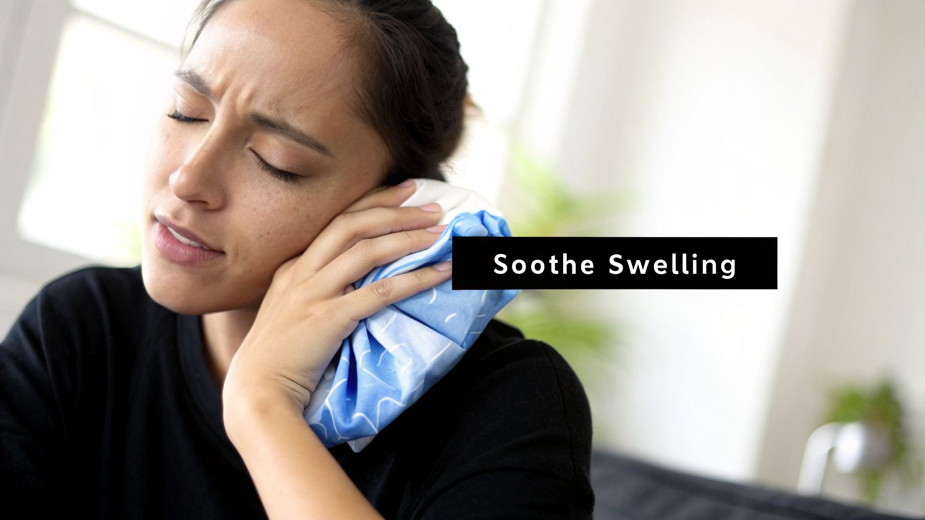 A distressed woman applies an ice pack to her cheek to soothe facial swelling or pain.