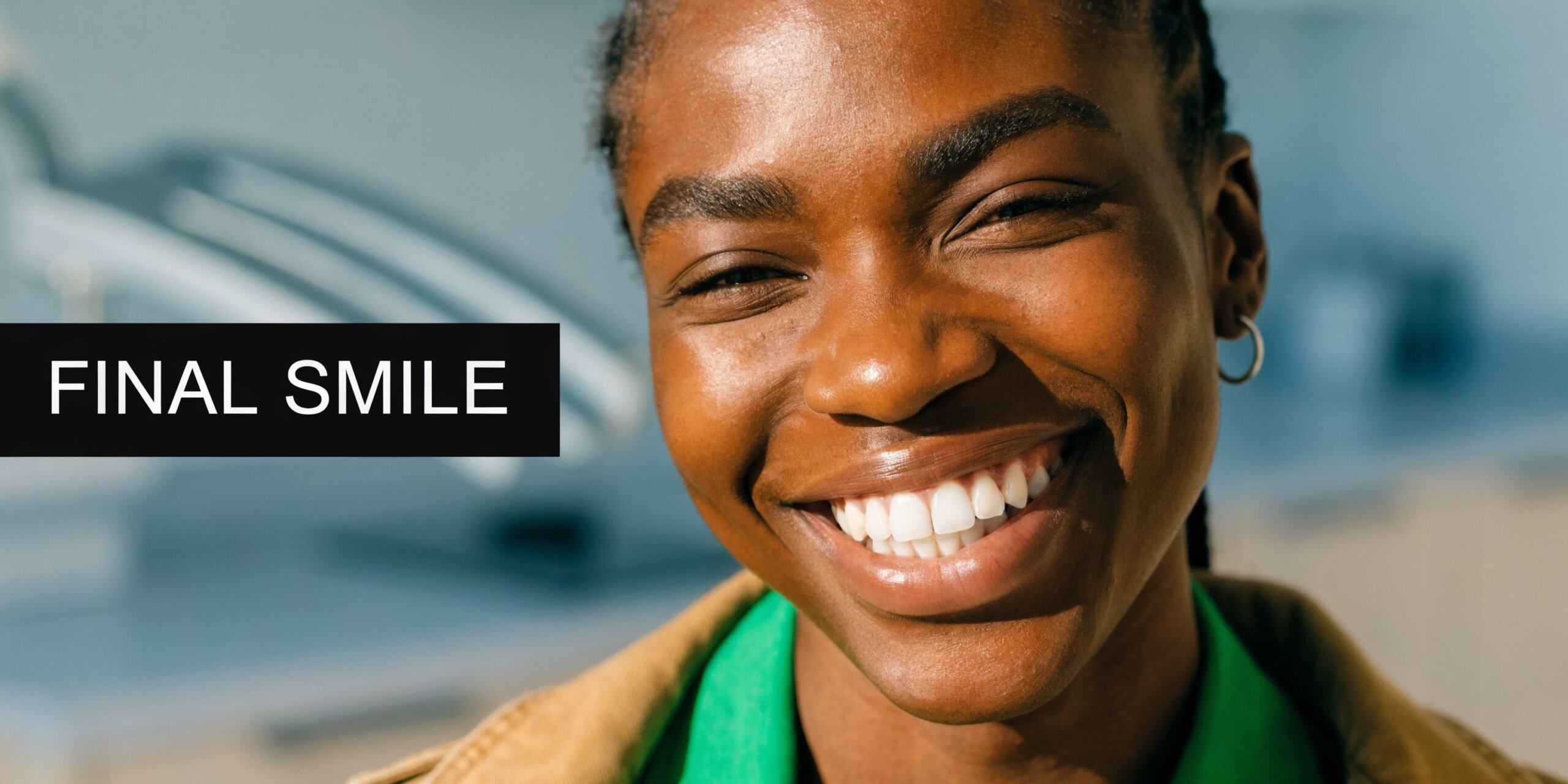 A happy young Black woman with a bright, healthy smile showcasing dental aesthetic improvements.