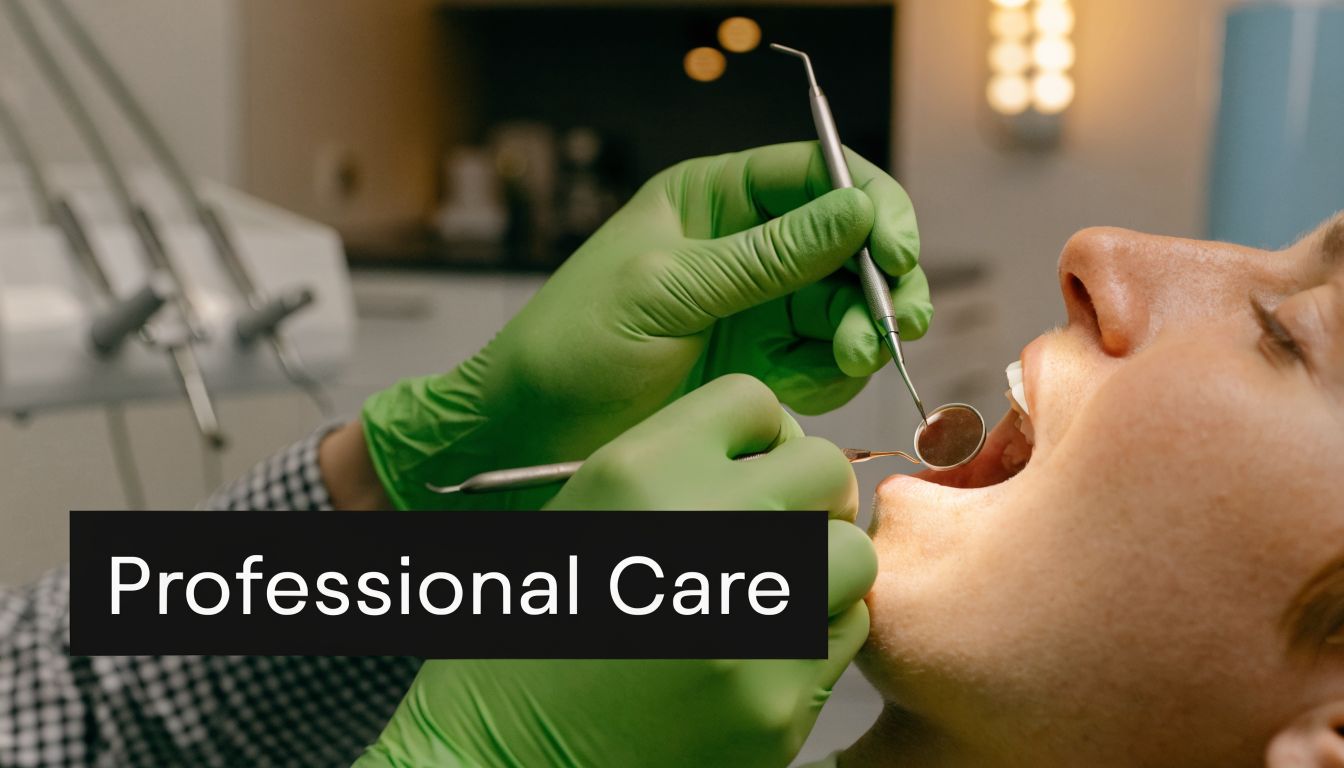 A dentist wearing green gloves performs a dental examination on a patient using a small mouth mirror.